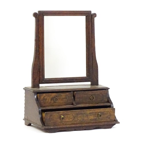 1737 - A mid 18thC oak toilet mirror with a rectangular glass above three short drawers set within a gradua... 