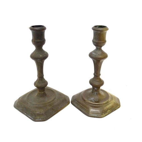 1186 - Two 18thC brass candlesticks with knop decoration to stem. Largest approx. 6 3/4