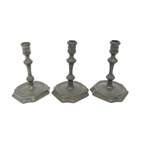 1186A - Three 18thC pewter candlesticks with knop detail to stems. Approx. 6