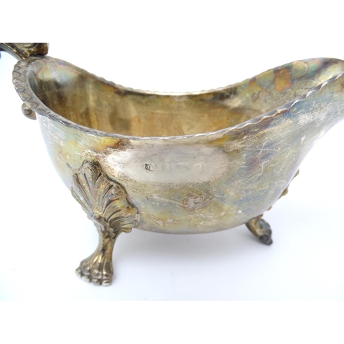 564 - A 19thC silver sauce boat raised on three feet, indistinctly marked. Approx. 7 1/2