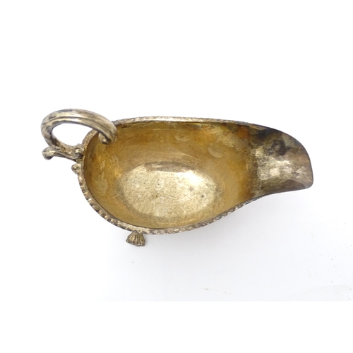 564 - A 19thC silver sauce boat raised on three feet, indistinctly marked. Approx. 7 1/2