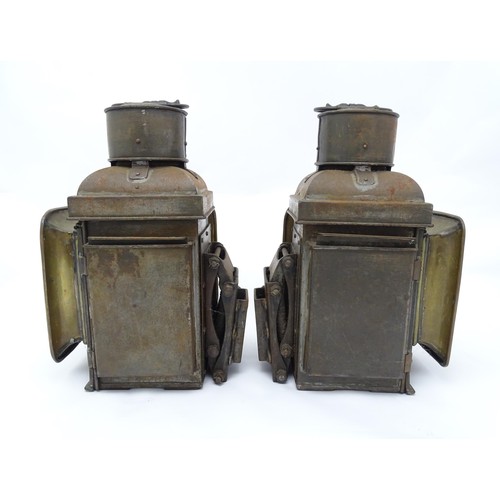 1289 - A pair of late 19thC railway / ship lanterns / lamps, each with two glass panels, a bracket to one s... 