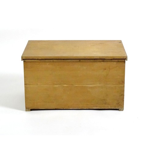 1711 - A 20thC pine trunk with a hinged lid, measuring 31