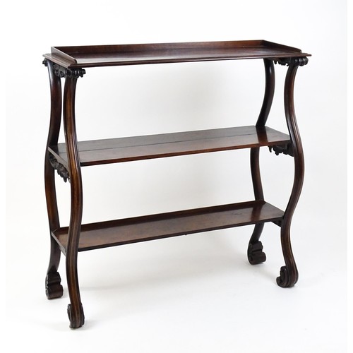 1712 - A late 18thC / early 19thC rosewood buffet / etagere with three tiers raised on four S formed moulde... 