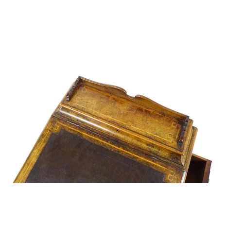 1675 - A mid / late 19thC burr walnut Davenport surmounted by a fitted writing box above a leather slope, t... 