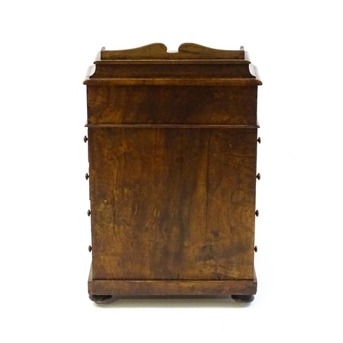 1675 - A mid / late 19thC burr walnut Davenport surmounted by a fitted writing box above a leather slope, t... 