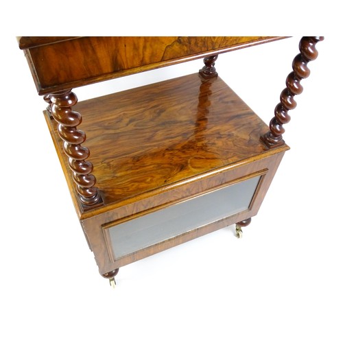 1677 - A late 19th century walnut whatnot / side cabinet surmounted by a pierced floral decorated upstand, ... 