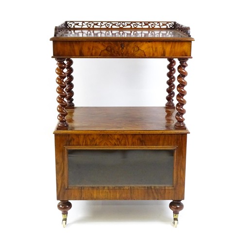 1677 - A late 19th century walnut whatnot / side cabinet surmounted by a pierced floral decorated upstand, ... 