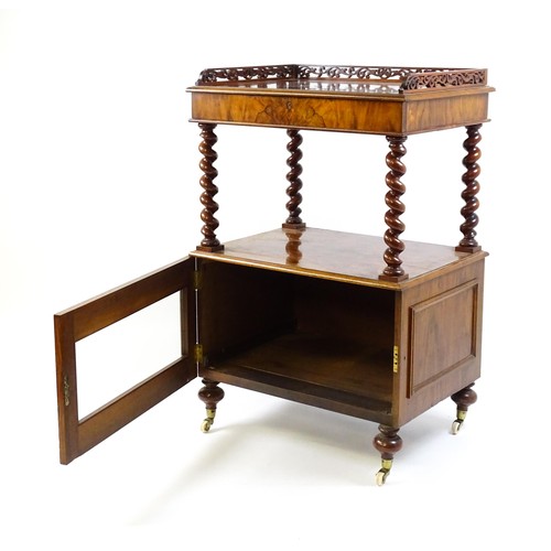 1677 - A late 19th century walnut whatnot / side cabinet surmounted by a pierced floral decorated upstand, ... 