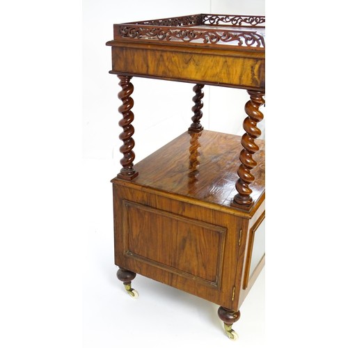 1677 - A late 19th century walnut whatnot / side cabinet surmounted by a pierced floral decorated upstand, ... 