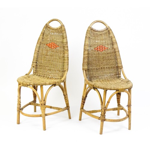 1686 - A pair of Dryad rattan side chairs with hoop handles to the top and raised on four legs with arched ... 