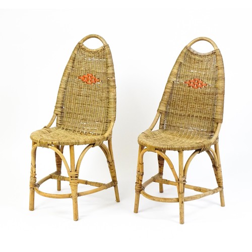 1686 - A pair of Dryad rattan side chairs with hoop handles to the top and raised on four legs with arched ... 