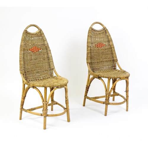 1686 - A pair of Dryad rattan side chairs with hoop handles to the top and raised on four legs with arched ... 