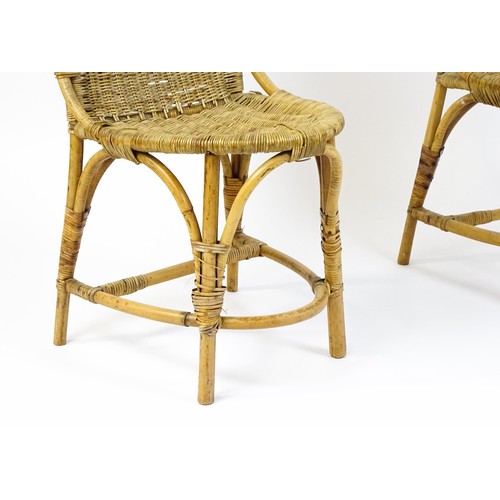 1686 - A pair of Dryad rattan side chairs with hoop handles to the top and raised on four legs with arched ... 