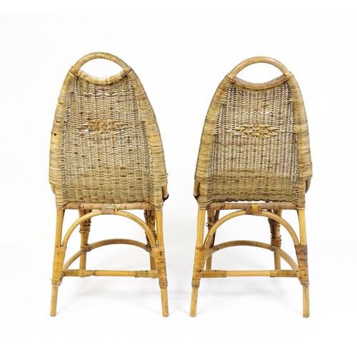 1686 - A pair of Dryad rattan side chairs with hoop handles to the top and raised on four legs with arched ... 