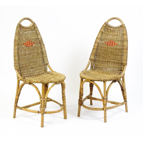 1686 - A pair of Dryad rattan side chairs with hoop handles to the top and raised on four legs with arched ... 