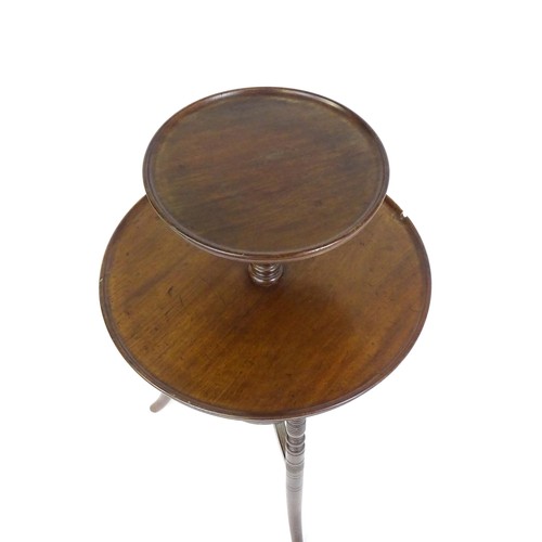 1560A - An Aesthetic movement walnut dumb waiter designed by E.W Godwin. The waiter having two dished tiers ... 