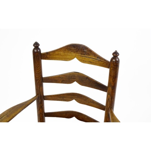 1555A - An early 19thC elm rush seated ladderback armchair, raised on turned tapering legs united by a box s... 