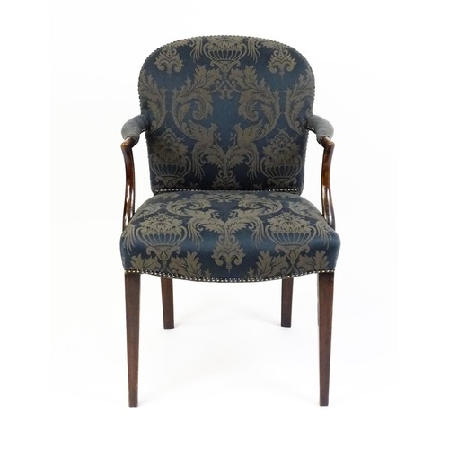 1585A - A late 19th century show wood desk chair with studded upholstery, swept arms and raised on straight ... 