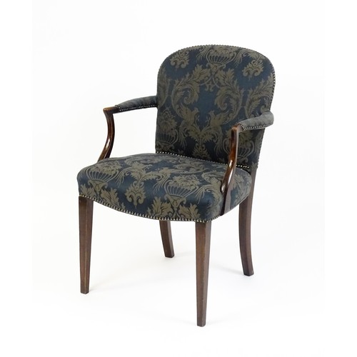 1585A - A late 19th century show wood desk chair with studded upholstery, swept arms and raised on straight ... 