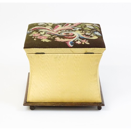 1584A - A Victorian ottoman with a needlework upholstered hinged top above four concave sides and raised on ... 