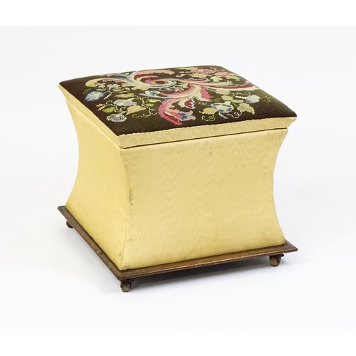 1584A - A Victorian ottoman with a needlework upholstered hinged top above four concave sides and raised on ... 