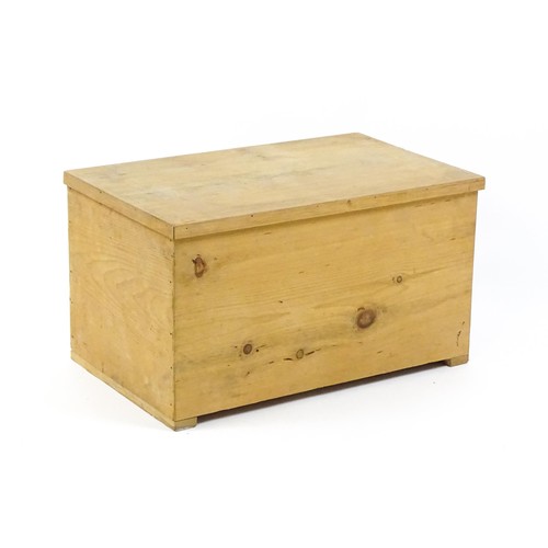 1711A - A 20thC pine trunk with a hinged lid, measuring 31