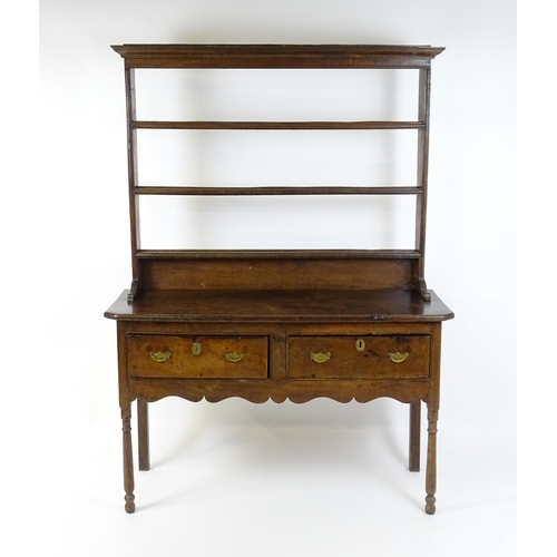 1583A - A mid / late 18thC oak Georgian dresser base with canted front corners with two short drawers having... 