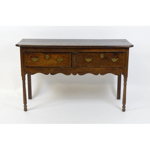 1583A - A mid / late 18thC oak Georgian dresser base with canted front corners with two short drawers having... 