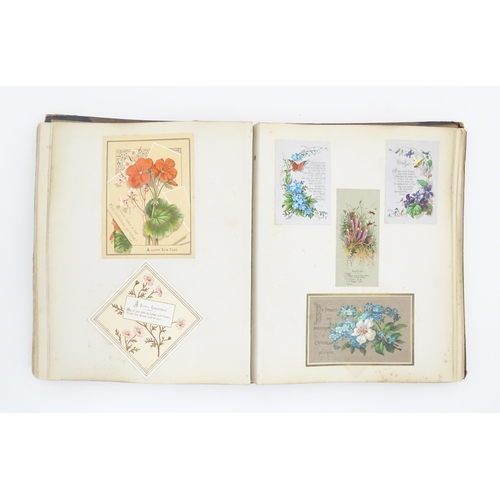 2137 - A Victorian scrapbook / scrap album containing various greetings cards to include Christmas Greeting... 