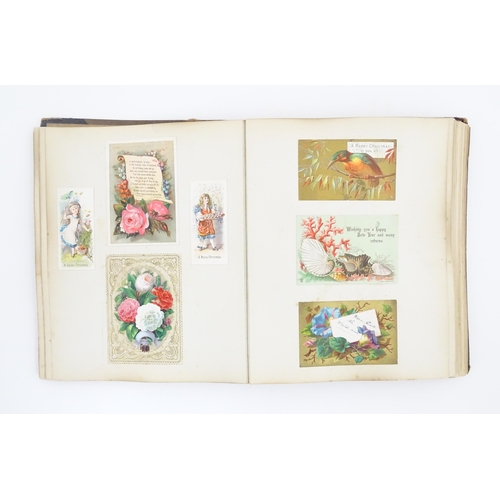 2137 - A Victorian scrapbook / scrap album containing various greetings cards to include Christmas Greeting... 