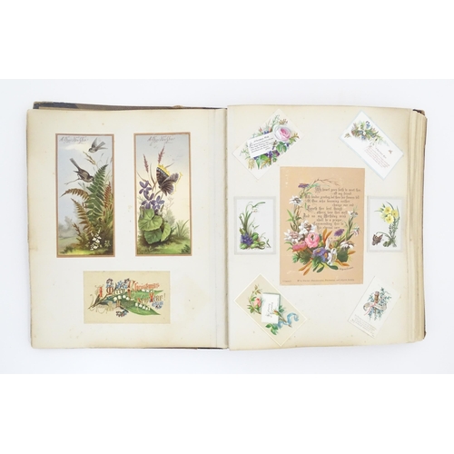 2137 - A Victorian scrapbook / scrap album containing various greetings cards to include Christmas Greeting... 