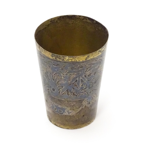 352 - A Russian silver vodka tot / shot cup with silver gilt and niello decoration. Marked under. Approx  ... 