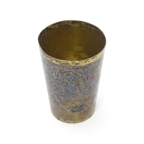 352 - A Russian silver vodka tot / shot cup with silver gilt and niello decoration. Marked under. Approx  ... 