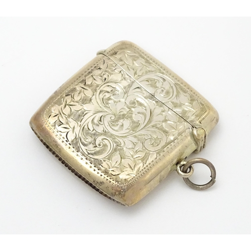 629 - A silver cigarette case and vesta case with engraved acanthus decoration, hallmarked Birmingham 1906... 