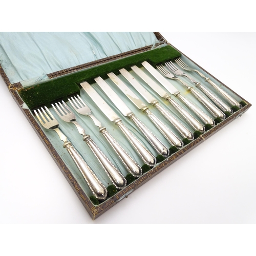 632 - A cased set of silver handled fruit knives and forks hallmarked Birmingham 1928, maker Raeno Silver ... 