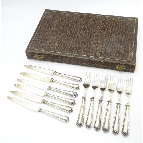 632 - A cased set of silver handled fruit knives and forks hallmarked Birmingham 1928, maker Raeno Silver ... 