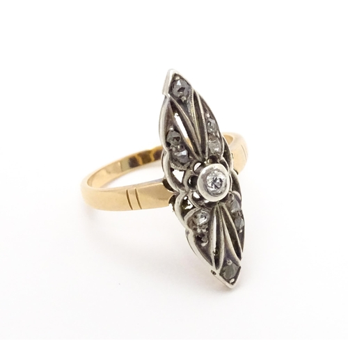 697 - A 19thC yellow gold ring set with central diamond flanked by a further 10 diamonds. Ring size approx... 