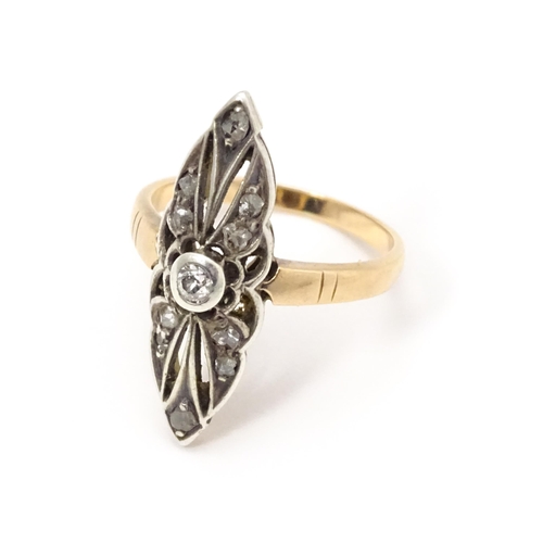 697 - A 19thC yellow gold ring set with central diamond flanked by a further 10 diamonds. Ring size approx... 