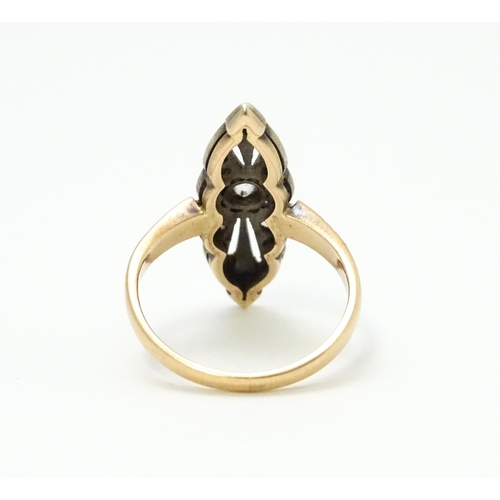 697 - A 19thC yellow gold ring set with central diamond flanked by a further 10 diamonds. Ring size approx... 