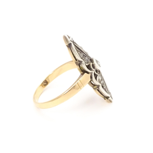 697 - A 19thC yellow gold ring set with central diamond flanked by a further 10 diamonds. Ring size approx... 