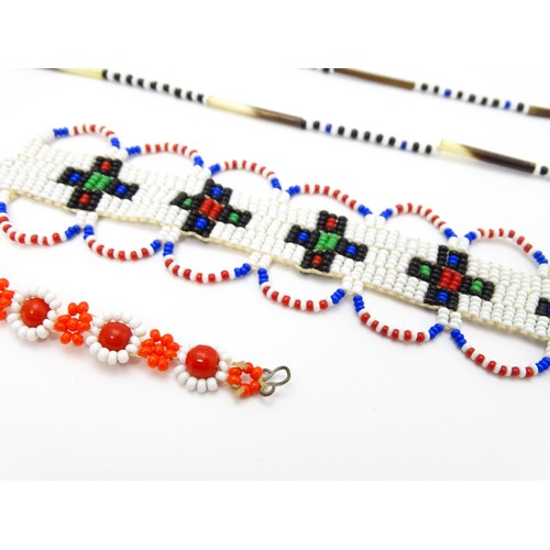 891A - A quantity of assorted beadwork jewellery to include necklaces, bracelets, etc. Some African example... 