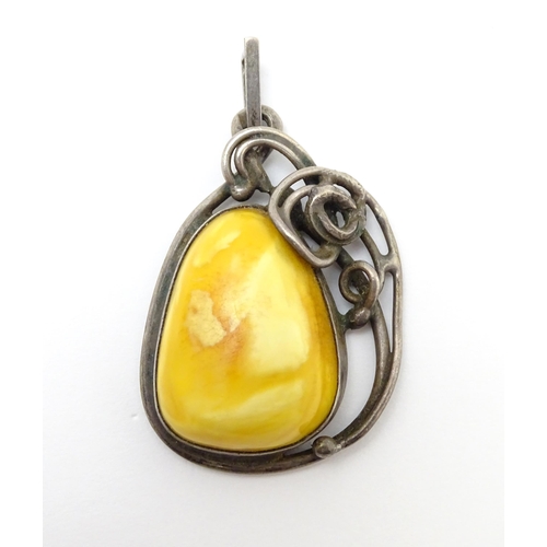 871A - Three items of jewellery to include a Polish silver pendant set with amber cabochon, a Lithuanian st... 