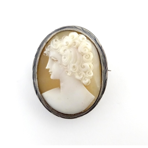 904A - A shell carved cameo brooch with white metal mount together with a brooch set with Wedgwood jasperwa... 