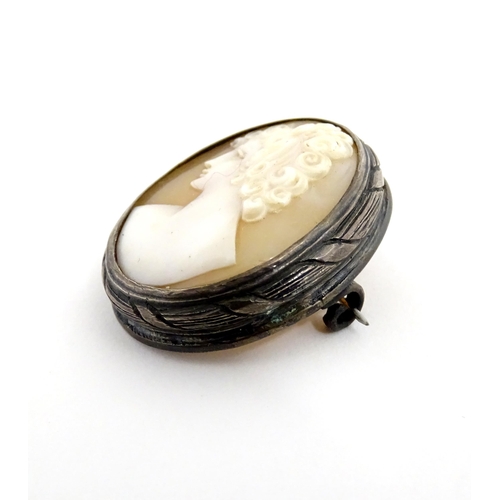 904A - A shell carved cameo brooch with white metal mount together with a brooch set with Wedgwood jasperwa... 