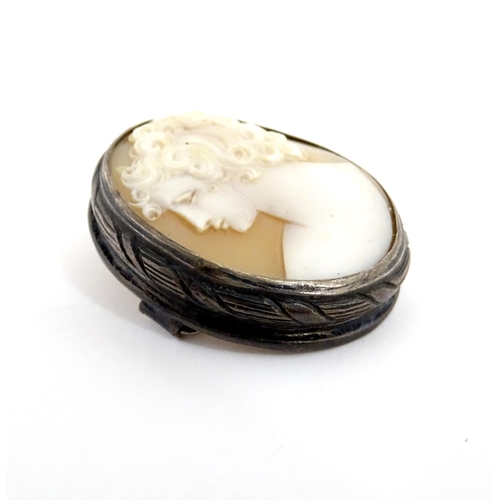 904A - A shell carved cameo brooch with white metal mount together with a brooch set with Wedgwood jasperwa... 