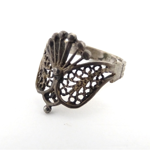 910A - A quantity of assorted jewellery comprising a Continental silver ring with filigree decoration, a wh... 