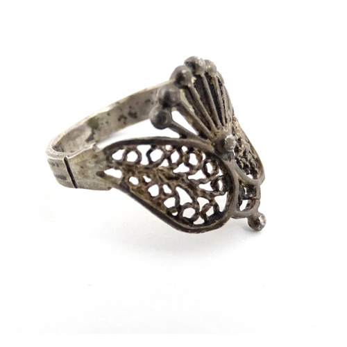 910A - A quantity of assorted jewellery comprising a Continental silver ring with filigree decoration, a wh... 