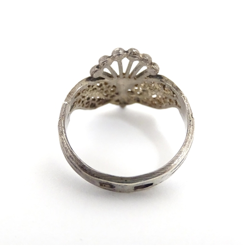 910A - A quantity of assorted jewellery comprising a Continental silver ring with filigree decoration, a wh... 