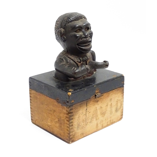 63 - A cast iron novelty money box / piggy bank titled 'Little Joe Bank'. Mounted on a wooden box. Approx... 